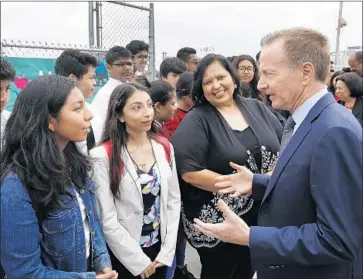  ?? Al Seib Los Angeles Times ?? NEW L.A. UNIFIED Supt. Austin Beutner speaks with students before his first news conference Wednesday at Belmont High School as board President Monica Garcia listens. “I’m about deeds, not words,” he said.