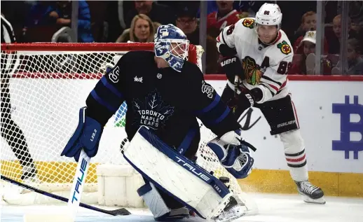  ?? ERIN HOOLEY/AP ?? Blackhawks star Patrick Kane scores off the backside of Maple Leafs goalie Ilya Samsonov in the second period to complete his hat trick Sunday.