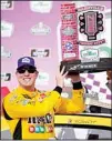  ?? (AP) ?? Kyle Busch, (front left), holds his trophy after winning a NASCAR Xfinity Series auto race, on June 19, in Lebanon, Tenn.