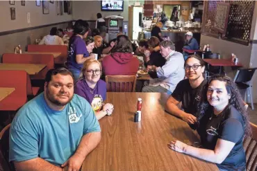  ??  ?? From left, Andrew Ishee, Molly Ishee, Adrian Ishee and Dewana Ishee at Broadway Pizza’s original location on Broad Avenue. The Ishees own and operate Broadway Pizza’s two locations in Memphis.