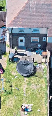  ??  ?? Forensics officers, left, at the house where the boys were found dead. Above, aerial view shows a uniformed officer in the back garden of the property