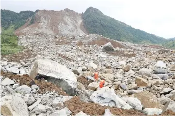  ??  ?? Rescue workers search for survivors at the site of the landslide in Nayong county, Guizhou province. — Reuters photo