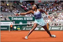  ?? JEAN-FRANCOIS BADIAS / AP ?? Coco Gauff of the U.S. returns the ball to Italy’s Martina Trevisan during their semifinal match of the French Open tennis tournament at the Roland Garros stadium Thursday in Paris.