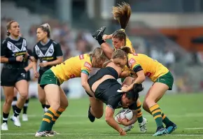  ?? GETTY IMAGES ?? Annetta Nuuausala of New Zealand is upended during the internatio­nal rugby league test against the Australia Jillaroos in Wollongong last night. The match was won by the home side 28-8.