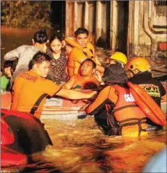  ?? MANMAN DEJETO/AFP ?? Rescue workers evacuate flood-affected residents in Davao on the southern Philippine island of Mindanao early on Saturday.