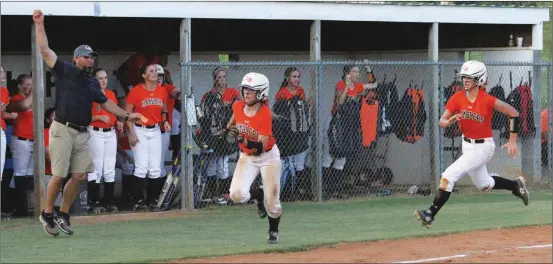  ??  ?? LaFayette head coach Glen Woodard waves home Nicky Yancy (front) and Jada Allmon. Both runners scored on a fifth-inning double by Kayleigh Goff that helped seal a 6-3 win over Pickens this past Thursday and moved the Lady Ramblers to 2-0 in Region...