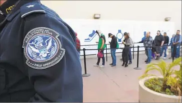  ?? Denis Poroy Associated Press ?? PEOPLE WAIT to enter the U.S. at the Otay Mesa Port of Entry in San Diego. In a lawsuit filed Friday, California argues that the new “public charge” regulation creates unnecessar­y barriers to eligible immigrants.
