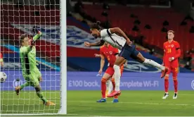  ?? Photograph: Tom Jenkins/NMC Pool/The Guardian ?? Dominic Calvert-Lewin powers a header past Wales’s Wayne Hennessey for a goal on his England debut.