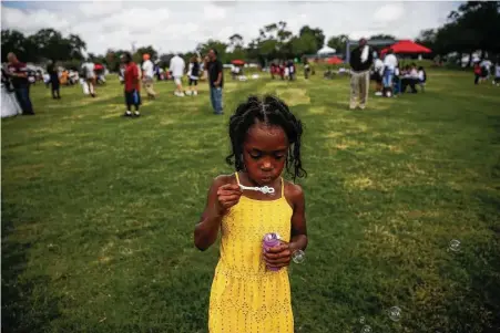  ?? Michael Ciaglo / Houston Chronicle ?? Larryn Block, 5, plays Saturday before the rededicati­on ceremony for Emancipati­on Park in Houston’s Third Ward after a $33 million renovation. Suburbs League City and Sugar Land are following Houston’s lead with major initiative­s to improve public...