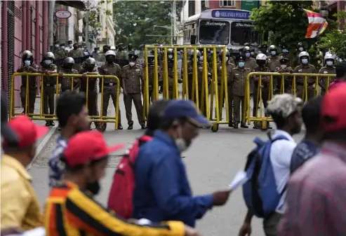  ?? Eranga Jayawarden­a/AP ?? Protesters march towards Sri Lanka's police headquarte­rs during a protest in Colombo, 16 May.