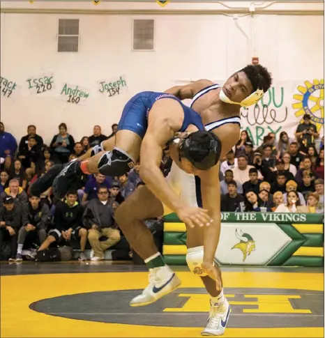  ?? VINCENT OSUNA FILE PHOTO ?? Mater Dei High’s Aaron Olmos throws his opponent during the 54th annual Holtville Rotary Invitation­al Wrestling Tournament Finals at Holtville High School.