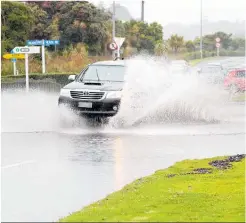  ?? Photos / Bevan Conley ?? From top: It was a day for umbrellas and raincoats. Trikes at Putiki Kindergart­en. Surface flooding on the corner of State Highway 3 and Taupo¯ Quay. Firefighte­rs pump water from the flooded Putiki Kindergart­en grounds.