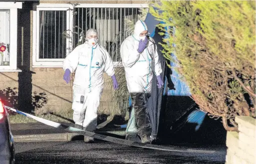  ??  ?? Forensic officers search for evidence at the scene of the tragedy