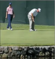  ?? TONY GUTIERREZ — THE ASSOCIATED PRESS ?? Phil Mickelson, right, putts as Jordan Spieth, left, watches on the fourth green during a practice round for the PGA Championsh­ip golf tournament at Baltusrol Golf Club in Springfiel­d, N.J., Tuesday.