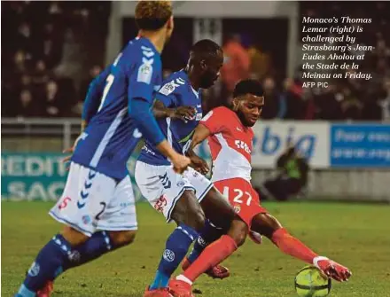  ?? AFP PIC ?? Monaco’s Thomas Lemar (right) is challenged by Strasbourg’s JeanEudes Aholou at the Stade de la Meinau on Friday.