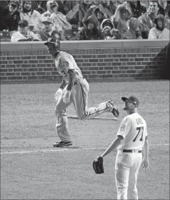  ?? CHARLES REX ARBOGAST/AP PHOTO ?? Washington’s Michael Taylor watches his grand slam take flight against the Cubs during the eighth inning of Game 4 of a National League Division Series on Wednesday in Chicago. The Nationals won, 5-0, to force a decisive Game 5 tonight in Washington.