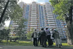  ?? THE ASSOCIATED PRESS ?? People look at a the apartment building Tuesday in Moscow damaged by a drone in an attack that authoritie­s blamed on Ukraine. While the U.S. has flooded Ukraine with military equipment since the war began in February 2022, officials have made clear they do not want it used to hit Russian territory.