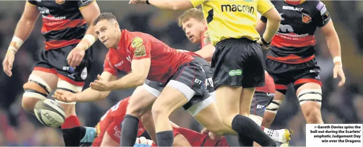  ??  ?? > Gareth Davies spins the ball out during the Scarlets’ emphatic Judgement Day win over the Dragons