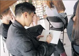  ?? Carolina A. Miranda Los Angeles Times ?? FEW JOBS for college students are as attractive or lucrative as simply selling class notes. Above, a student takes notes at a design studio in Mexico City.