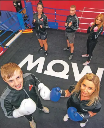  ?? Photograph: Iain Ferguson, alba.photos. ?? Jayne MacKay of Mowi takes on boxing champion and Mowi employee Cameron Whyte on the new ring canvas donated to Lochaber Phoenix Boxing Club by the company.