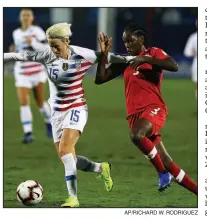  ?? AP/RICHARD W. RODRIGUEZ ?? Forward Megan Rapinoe (15) of the United States and Canada’s Kadeisha Buchanan battle for possession of the ball Wednesday during the first half of the CONCACAF Women’s Championsh­ip final in Frisco, Texas. The United States won 2-0.