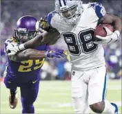  ?? Hannah Foslien Getty Images ?? DEZ BRYANT of the Cowboys fends off Xavier Rhodes of the Vikings in the fourth quarter.