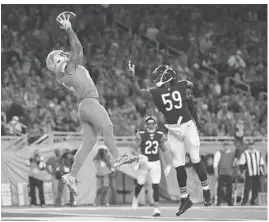  ?? GREGORY SHAMUS/GETTY IMAGES ?? Detroit tight end Eric Ebron catches a touchdown pass over Chicago inside linebacker Danny Trevathan during the third quarter on Saturday in Detroit.