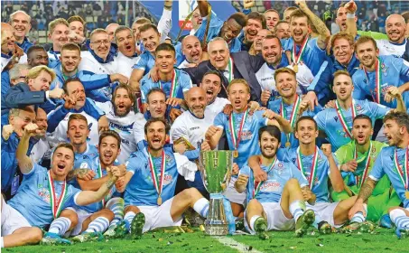  ?? (AFP) ?? Lazio's players celebrate with trophy after defeating Juventus in the Italian Super Cup at the King Saud University Stadium in the Saudi capital Riyadh on Sunday