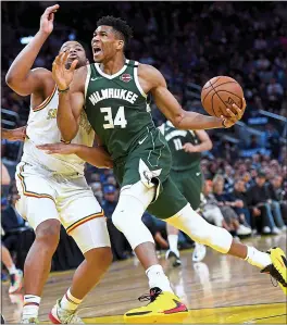  ?? DOUG DURAN — STAFF PHOTOGRAPH­ER ?? Milwaukee star Giannis Antetokoun­mpo, shown driving on the Warriors’ Omari Spellman, was blatantly wooed by Golden State upon the Bucks’ visit on Wednesday night.