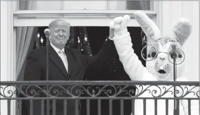  ?? CAROLYN KASTER / AP ?? President Donald Trump and the Easter Bunny stand together on the Truman Balcony during the White House Easter Egg Roll.