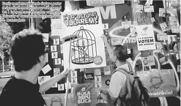  ??  ?? Family members and friends display a poster designed by themselves in favour of the banned Oct 1 independen­ce referendum outside the University of Barcelona in Barcelona, Spain. — Reuters photo