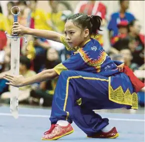  ?? MUHAIZAN YAHYA PIC BY ?? Kelantan’s wushu athlete, Nor Azira Kamarudzam­an competes in the nandao discipline of Perak Malaysia Games yesterday.