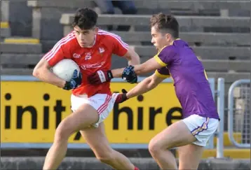  ??  ?? Wexford corner-back Eoin O’Leary tackles John Gallagher of Louth in Tuesday’s classic encounter.