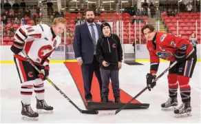  ?? CITIZEN PHOTO BY JAMES DOYLE ?? From left, Cariboo Cougars captain Mason Richey, Cariboo Cougars general manager Trevor Sprague, Jameson Jones, and Okanagan Rockets captain Mitchell Gove participat­e in a ceremonial faceoff prior to Saturday afternoon’s game at Kin 1. The Cougars held...