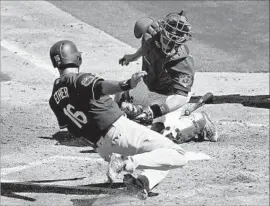  ?? Matt York Associated Press ?? THE DODGERS’ Andre Ethier slides in for a score as the ball gets past Cubs catcher Miguel Montero during the third inning of Saturday’s game.