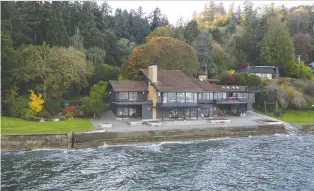  ?? PHOTOS: ROBERT BRITTINGHA­M ?? This stunning home on Vashon Island in Washington is accessible only by ferry or private boat. The boat house will accommodat­e a 60-foot boat.