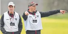  ??  ?? James Kelly runs a drill watched by Bombers coach John Worsfold.