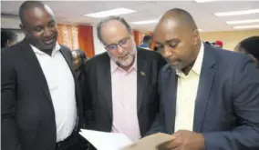  ?? (Photo: Garfield Robinson) ?? Opposition Leader Mark Golding (centre), flanked by the party’s spokesman on finance Julian Robinson (right) and its General Secretary Dr Dayton Campbell during a media briefing at the party’s headquarte­rs on Friday