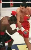  ?? ASSOCIATED PRESS FILE ?? Wladimir Klitschko, right, punches challenger Hasim Rahman during their 2008 IBF, WBO, IBO title fight in Mannheim, Germany.