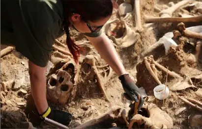  ?? Cesar Manso/AFP/Getty Images ?? The remains of people dumped in mass graves over the summer of 1936 during the Spanish Civil War.