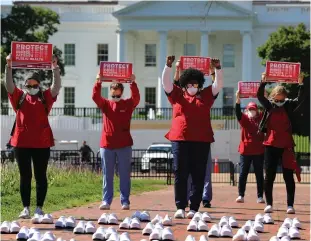  ?? Tribune News Service/getty Images ?? Members of the National Nurses United observe a moment of silence for the 88 nurses they say have died from COVID-19 while demonstrat­ing in Lafayette Park across from the White House in May 2020 in Washington, D.C.