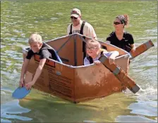  ?? John Popham ?? Cave Spring students Donnie Robert Holmes (front left) and Ginny Gresham (front right) paddled to the far side of Rolater Lake and made a successful trip back across with a little help from Floyd County Schools Instructio­nal Technology Specialist­s Nathan Medley (back left) and Emily Stallings. See more photos on page A2