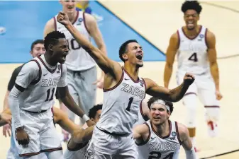  ?? Michael Conroy / Associated Press ?? Guard Jalen Suggs (1) celebrates making the gamewinnin­g basket — a bank shot from near halfcourt — against UCLA in overtime, sending undefeated Gonzaga to the final against Baylor.