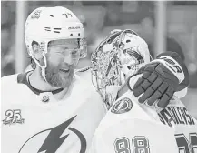  ?? Maddie Meyer / Getty Images ?? The Lightning’s Victor Hedman, left, shows his appreciati­on for Andrei Vasilevski­y after the goalie stopped 28 of 29 shots.