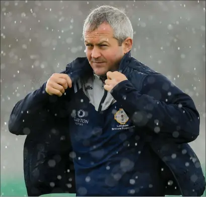  ??  ?? Ciarán Deely dealing with the elements during his last game in charge of the London Senior footballer­s - their All-Ireland qualifier clash with Offaly in June, 2019.