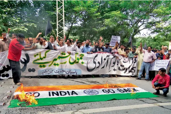  ?? EPA ?? A MOCK INDIAN FLAG BEING BURNT DURING A PROTEST IN MUZAFFARAB­AD FOLLOWING MODI’S I-DAY SPEECH