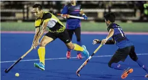  ?? — RONNIE CHIN / The Star ?? Too fast: Perak’s Muhammad Haziq Samsul (left) dribbling past Johor’s Mohamad Zaki Ismail during the Razak Cup Group B match at the Azlan Shah Stadium in Ipoh yesterday.