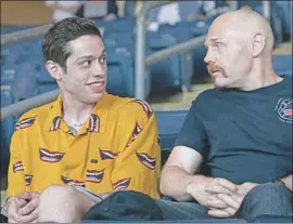  ?? Mary Cybulski Universal Pictures ?? THE RECKLESS Scott (Pete Davidson), left, and devoted firefighte­r Ray (Bill Burr) share an uneasy connection in Judd Apatow’s “The King of Staten Island.”