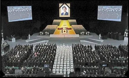  ?? ?? attendees at a state funeral for former Japanese Prime Minister Shinzo abe at the Nippon budokan Hall in tokyo on Sept 27. — TAKASHI aoyama/getty Images/bloomberg