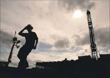  ?? Luis Sinco Los Angeles Times ?? AN EMPLOYEE of Northern Dynasty Minerals at a drilling rig near Iliamna, Alaska. The Canadian company is proposing to develop Pebble Mine, which has long been opposed by environmen­talists and fisheries.